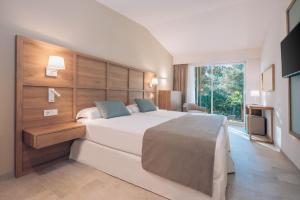 A bed or beds in a room at Iberostar Waves Cala Domingos All Inclusive