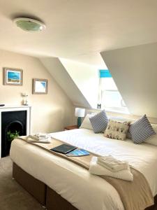 a bedroom with a bed with a laptop on it at The Mayfair in Weymouth