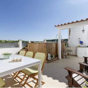 a patio with a white table and chairs and a fence at Casa Do Bispo pereiro,Arganil in Coimbra