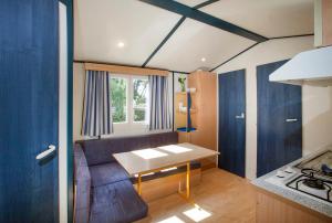 a kitchen with a couch and a table in a room at Camping la Croix du Sud in Saint-Tropez +37 photos