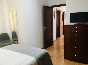 Televízia a/alebo spoločenská miestnosť v ubytovaní Apartamento Praia de Quenxe
