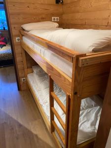 a couple of bunk beds in a room at Studio Confortable style Chalet, Saint Lary Soulan centre village, 6 nuits minimum in Saint-Lary-Soulan