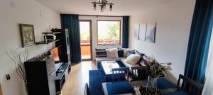 a living room with a couch and a table at Neviasta Apartment in Smolyan