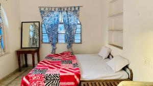 a small bedroom with a bed and a window at Sai Baba Haveli in Pushkar