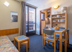 a small room with a table and a room with a window at Résidence Pierre & Vacances Inter-Résidences in Tignes +28 photos