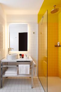 a bathroom with a sink and a shower at Mama Shelter Paris La Défense in Puteaux