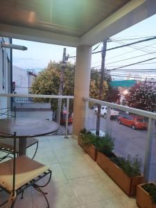 balcón con mesa y vistas a un aparcamiento en Paula departamento en Salta