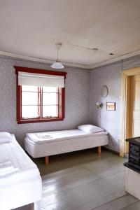 Ein Bett oder Betten in einem Zimmer der Unterkunft Taattisten Tila - Taattinen Farm and Cottages