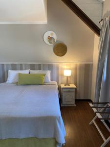 a bedroom with a bed and a table with a lamp at Hostería Las Nieves in Villa La Angostura