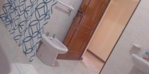 a bathroom with a toilet and a sink at Cubico Tota in Praia