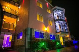 a building with colorful lights on the side of it at Acactus Hotel in Kampala