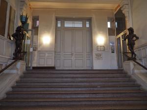 a staircase leading to a large door in a building at Le Bigorneau , beach at 20m and free private carpark in Saint Malo