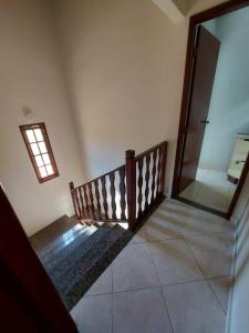 a staircase in a room with a window and a mirror at Saquarema - Condomínio Residencial Iate hotel. in Saquarema