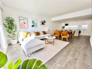 un soggiorno con divano bianco e tavolo di Home Out Vilamoura 20 Levante a Vilamoura