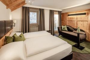 Postel nebo postele na pokoji v ubytování Boutique & Fashion Hotel Maciaconi - Gardenahotels