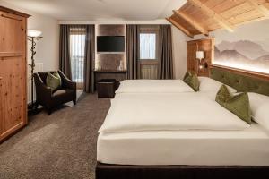 Postel nebo postele na pokoji v ubytování Boutique & Fashion Hotel Maciaconi - Gardenahotels