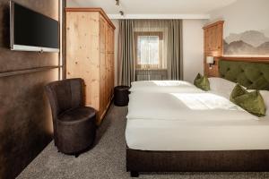 Postel nebo postele na pokoji v ubytování Boutique & Fashion Hotel Maciaconi - Gardenahotels