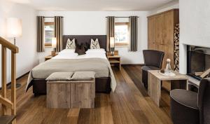 Postel nebo postele na pokoji v ubytování Boutique & Fashion Hotel Maciaconi - Gardenahotels