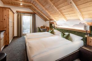 Postel nebo postele na pokoji v ubytování Boutique & Fashion Hotel Maciaconi - Gardenahotels