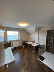 a large bathroom with a tub and a sink at Kleine Auszeit in Goslar