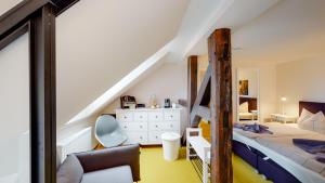 a bedroom with a bunk bed and a staircase at Biohotel Schönhagener Mühle in Pritzwalk
