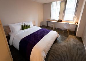 Postel nebo postele na pokoji v ubytování Metro Hotel Myeongdong