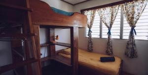 a bedroom with a bunk bed and a window at Spanish by the River - Boquete in Boquete