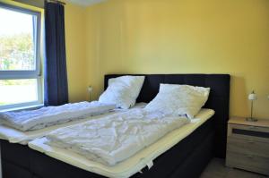 two beds with white sheets and pillows in a bedroom at Ostseeresidenz - Whg 19 in Zingst
