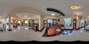 a large room with a lobby with a bar at Vinci Hotel Airport in Modlniczka
