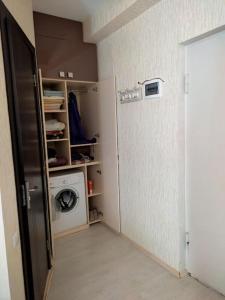 a laundry room with a washer and a washing machine at Уютная и светлая квартира с видом на горы in Tbilisi City +26 photos