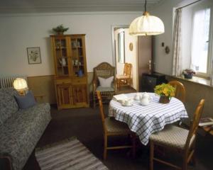 sala de estar con mesa y sofá en Maiergschwendter-Hof en Ruhpolding