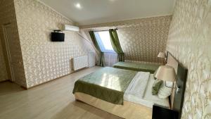 a bedroom with a bed and a dresser at Vista Hotel in Krasnodar