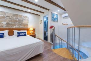 a bedroom with a bed and a stone wall at New Apartment La Barca Old Town in Dubrovnik