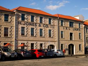 a building with cars parked in front of it at The Henry Jones Art Hotel in Hobart