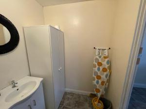 a bathroom with a sink and a white cabinet at A lovely one bedroom Condo with free parking in Patchway in Bristol