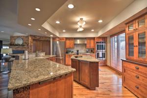 a large kitchen with wooden cabinets and granite counter tops at Charming Joliet Ranch House on a Working Farm in Silesia