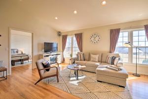 a living room with a couch and a table at Pet-Friendly Cottage with Game Room and Fire Pit! in Syria