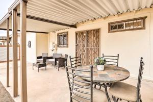 a patio with a table and chairs and a dining room at Sunny Tucson Abode with Fire Pit 9 Mi to U of A in Tucson