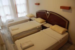 a group of four beds in a room at Luxor apartments in Alanya +11 photos