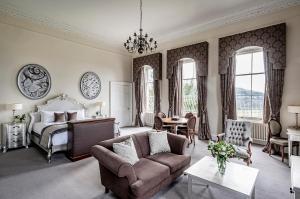 a living room with a bed and a couch at Bailbrook House Hotel, Bath in Bath