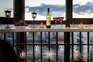 two glasses of wine on a table with a window at Apartment with a beautiful view lxt by in Grodno