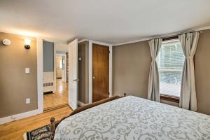 a bedroom with a bed and a window at Kennebunk Home with Yard Less Than 1 Mile to Dock Square! in Kennebunk