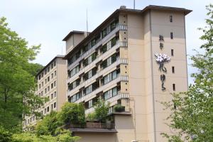 a building with a clock on the side of it at Ryotei Hanayura in Noboribetsu