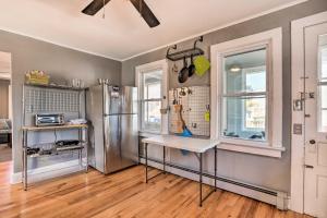 a kitchen with a table and a refrigerator at Pet-Friendly Belmar Cottage Less Than 1 Mi to Beach! in Belmar