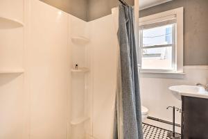 a white bathroom with a shower and a sink at Pet-Friendly Belmar Cottage Less Than 1 Mi to Beach! in Belmar