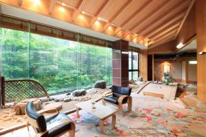 a large living room with a large glass window at Ryotei Hanayura in Noboribetsu