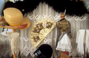 a display of hats and a mannequin on a wall at Autrefois La Modiste in Saint-Clar