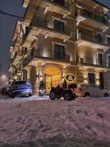 a quad bike parked in front of a building at Legacy Boutique Hotel in Korçë