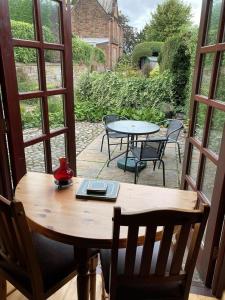 a wooden table with a laptop on top of it at Belmont Cottage in Dumfries