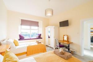 a living room with two beds and a window at Dourie Farmhouse in Port William